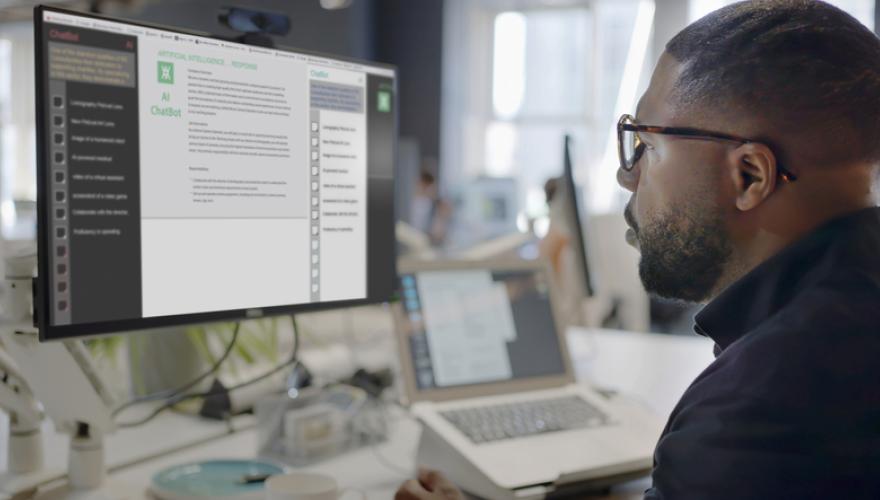 man at computer viewing AI application