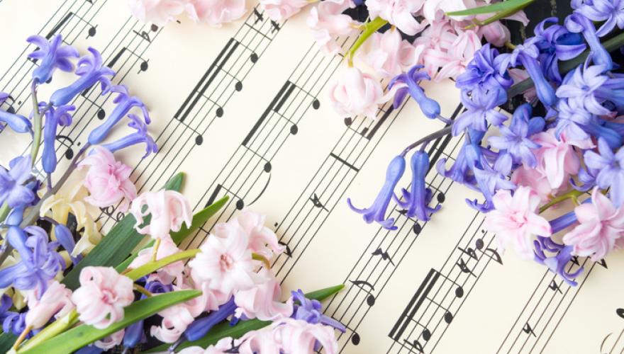 sheet music underneath flowers