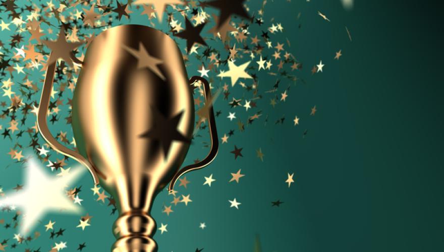 gold award with green background and confetti stars