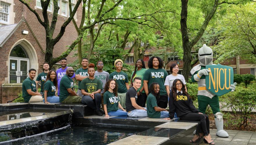 students smiling at the fountain with Gothic Knight