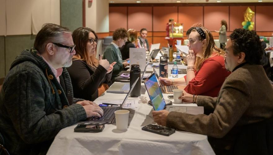 group of adults with laptops in GSUB conference