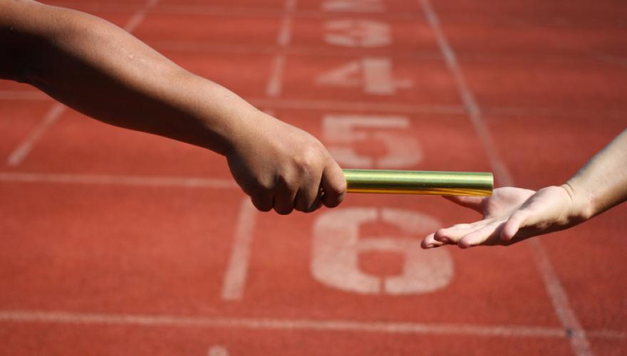 Relay race hand-off closeup