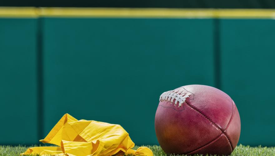 football and flag on grass -green gold