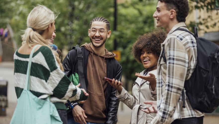 students gathered laugh and greet
