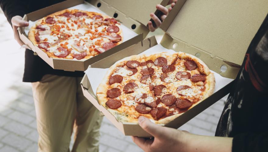 offering of pizza from open boxes