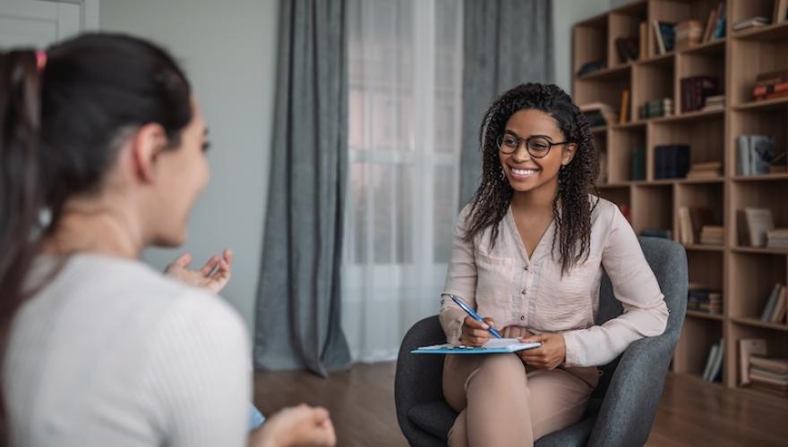 smiling female doctor consulting woman