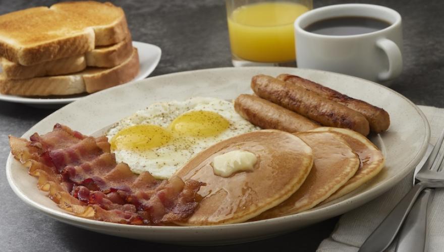 breakfast meal on table with juice and coffee