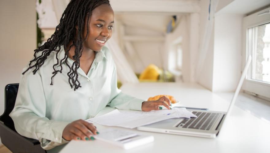 woman at laptop smiling