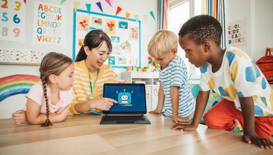 students and teacher using laptop