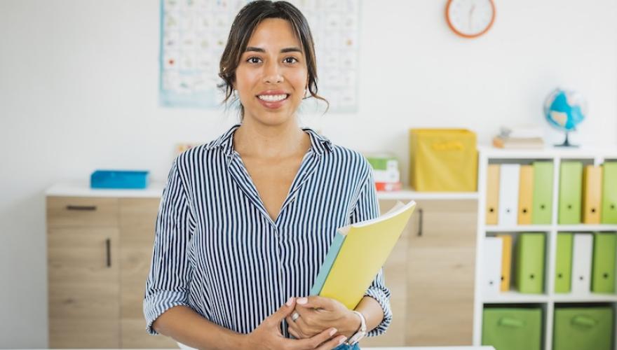 young female teacher with book