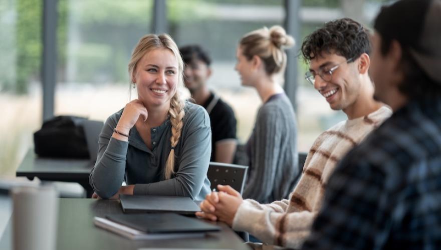 students in classroom smile and interact