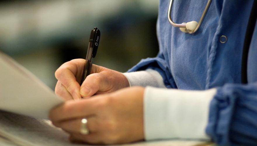 nurse filling out paperwork