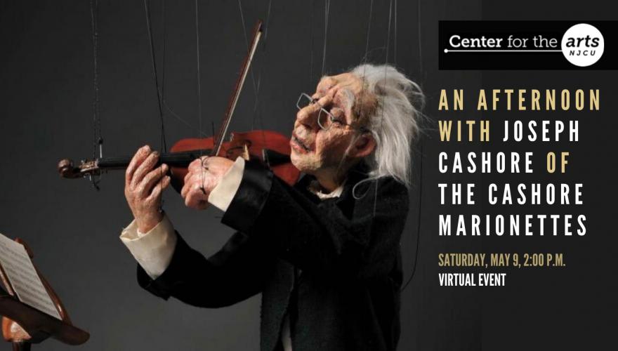 Old man puppet playing violin