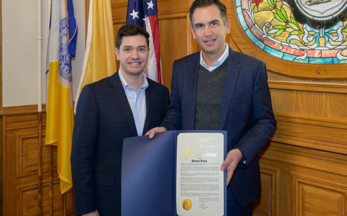 Mayor Fulop presents a proclamation to President Acebo
