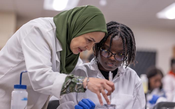 NJCU Biology Professor Meriem Bendaoud works with a microbiology student.