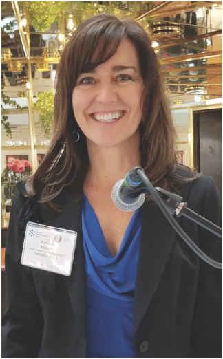 Dr. Rennie behind a microphone at the World PR Forum in Oslo, Norway.