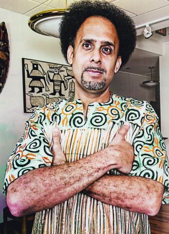 Will Guzman standing with arms folded.