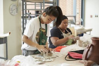 female students working in ceramics room