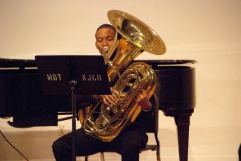 Student Playing a Tuba Onstage