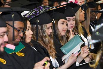 students in a row at commencement