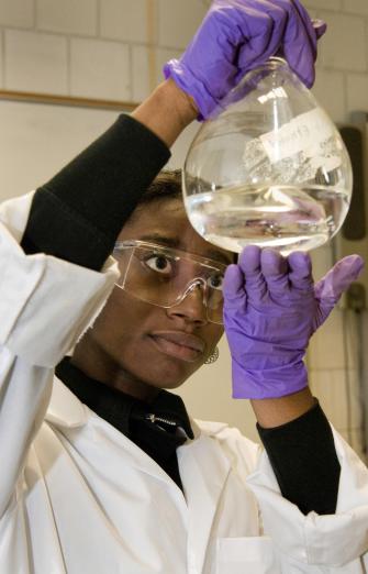 A chemistry student looking at a sample.