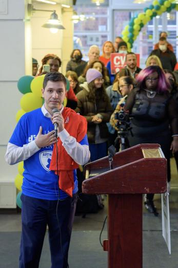 President Acebo speaking during a rally to fund NJCU in 2023, wearing an AFT 1839 shirt with his hand over his heart.