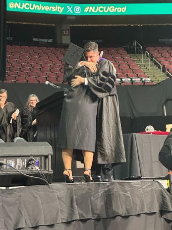 President Acebo hugs the final graduate, NJCU employee Sonya Brown.jpg
